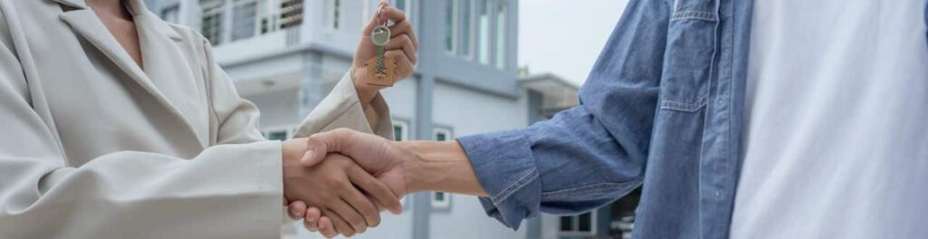 first time buying a home shaking hands with realtor