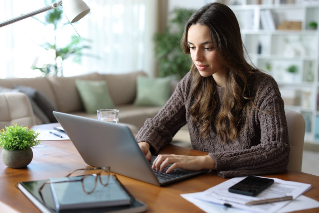 How to Apply for Unemployment if You Were Laid Off Tele worker working online at home using laptop