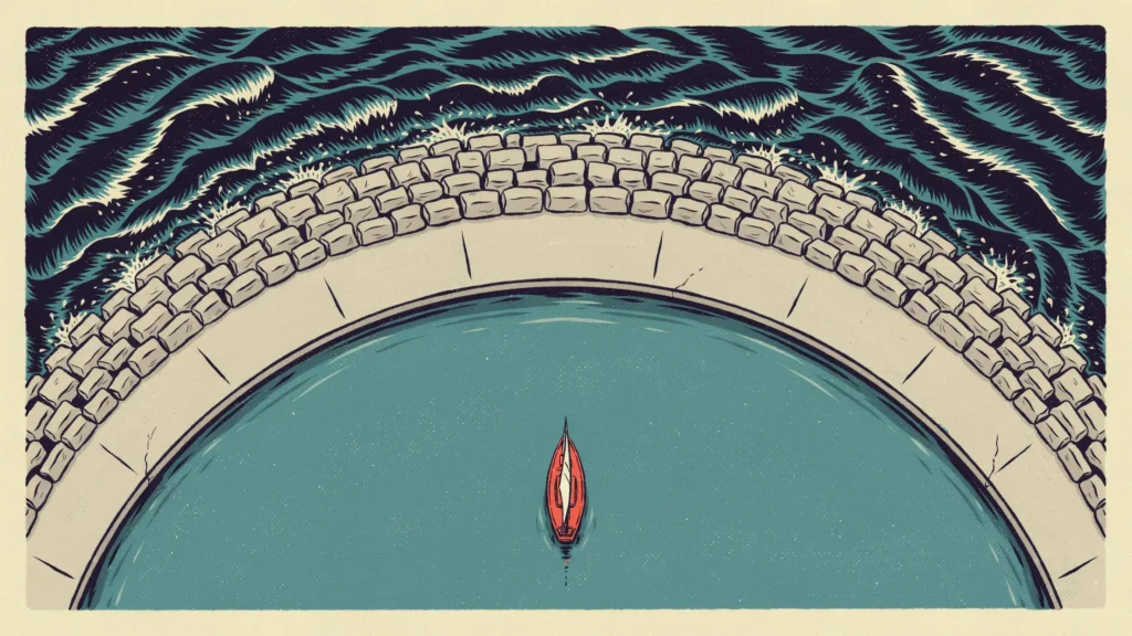 Aerial view of a curved stone breakwater sheltering a small red sailboat on calm teal water from dark waves outside.